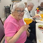 Charter Senior Living of Dedham in Dedham, MA, resident enjoying a drink and good company