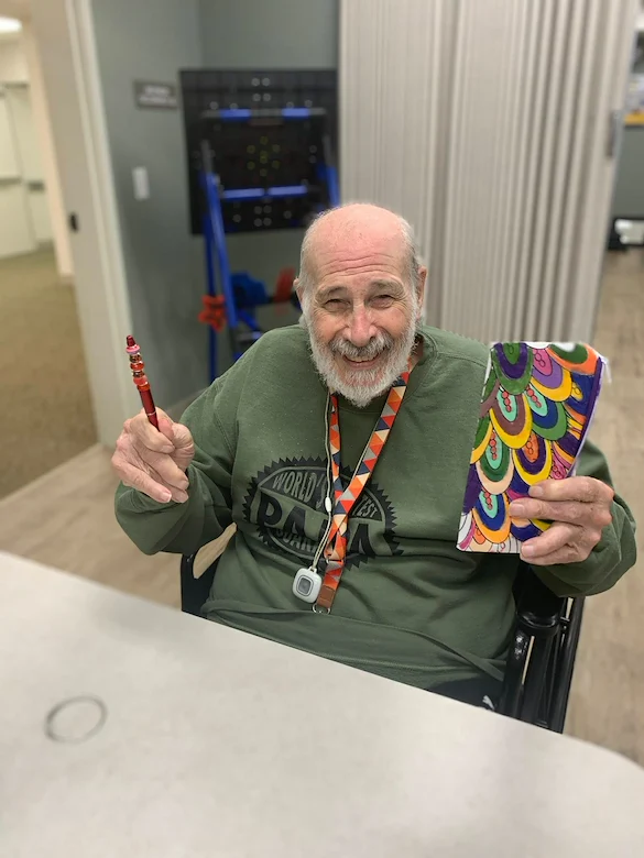 Charter Senior Living of Brookfield resident smiles with crafts