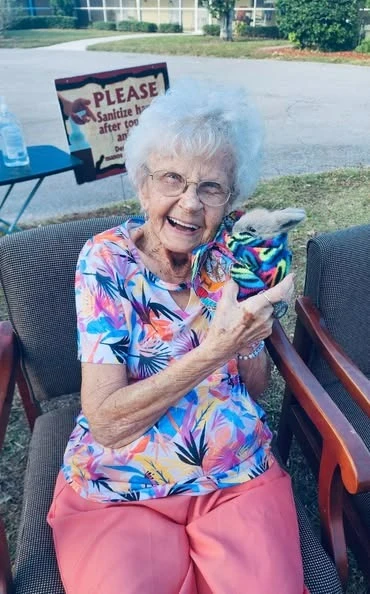 Hidden Lakes Senior Living Community Vero Beach, FL, smiling resident with a bunny