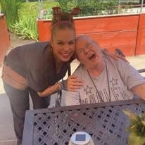 Grande Ronde Retirement Residence senior living community offering independent living, assisted living, and respite care in La Grande, OR, resident smiling with a staff member