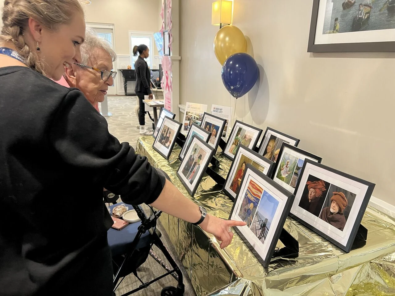 Resident and Staff looking at Pictures
