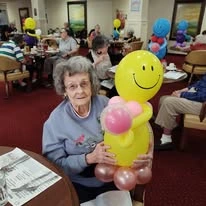Summerville Estates Gracious Retirement Living Hawthorn Senior Independent Living in Summerville, South Carolina resident holding a balloon craft
