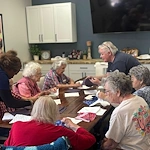 Seniors at Charter Senior Living of Hermitage in Hermitage, TN, individually working on fabric craft projects, encouraging creativity and personal expression in independent living, assisted living, and memory care.
