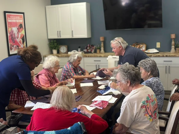 Seniors at Charter Senior Living of Hermitage in Hermitage, TN, individually working on fabric craft projects, encouraging creativity and personal expression in independent living, assisted living, and memory care.