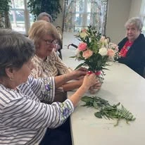 Orchard Heights Gracious Retirement Living Hawthorn Senior Independent Living in Clermont, Florida residents designing flower bouquets