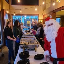The Stafford Senior Living in Lake Oswego, Oregon residents at a Christmas party with Santa Claus