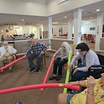 Pathfinder Senior Living in Fremont, NE, residents having fun staying active during a fun activity with pool noodles