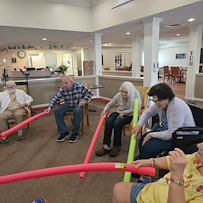 Pathfinder Senior Living in Fremont, NE, residents having fun staying active during a fun activity with pool noodles