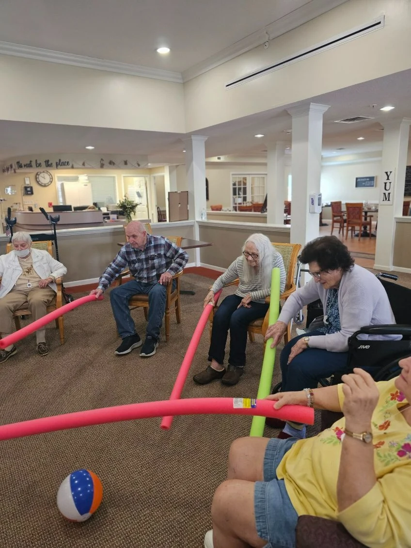 Pathfinder Senior Living in Fremont, NE, residents having fun staying active during a fun activity with pool noodles