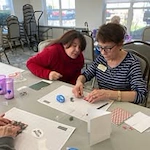 resident doing a craft at The Highlands Gracious Retirement Living Hawthorn Senior Independent Living in Westborough, Massachusetts