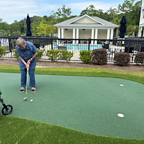 The Barclay at Little River resident putting and enjoying the outdoors