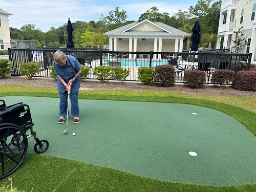The Barclay at Little River resident putting and enjoying the outdoors
