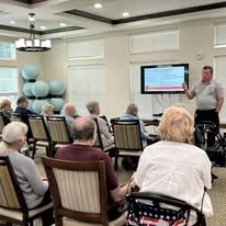 Camellia Gardens Gracious Retirement Living Hawthorn Senior Independent Living in Maynard, Massachusetts residents listening to policies and procedures
