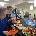 Whispering Pines Gracious Retirement Living Hawthorn Senior Independent Living in Raleigh, North Carolina residents getting a snack