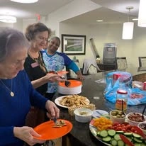Whispering Pines Gracious Retirement Living Hawthorn Senior Independent Living in Raleigh, North Carolina residents getting a snack