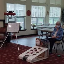 Providence Meadows Gracious Retirement Living Hawthorn Senior Independent Living in Charlotte, North Carolina resident playing games inside