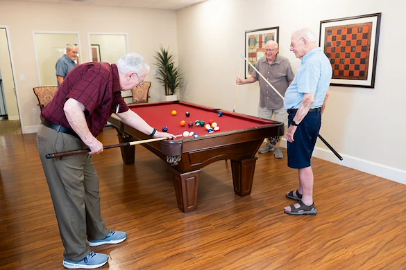 Playing pool in the game room at Fellowship Square Surprise