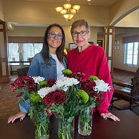 Credo Senior Living - Wichita, KS, resident with floral arrangements from activity