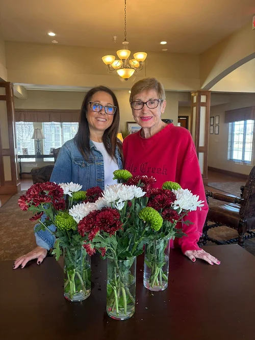Credo Senior Living - Wichita, KS, resident with floral arrangements from activity