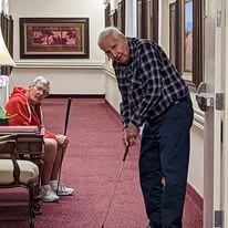 Scholl Canyon Estates Gracious Retirement Living Hawthorn Senior Independent Living in Glendale, California resident playing mini golf indoors
