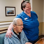 Concord Place Senior Memory Care in Knoxville, TN resident socializing with a staff member