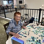 Charter Senior Living of Brookfield resident enjoying doing a puzzle