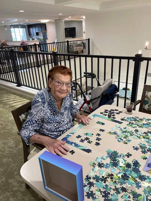 Charter Senior Living of Brookfield resident enjoying doing a puzzle