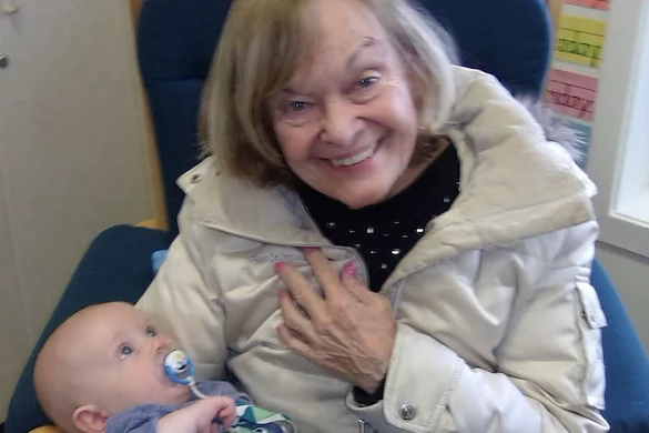 Porter Place Assisted Senior Living Memory Care in Tinley Park, IL resident holding a baby