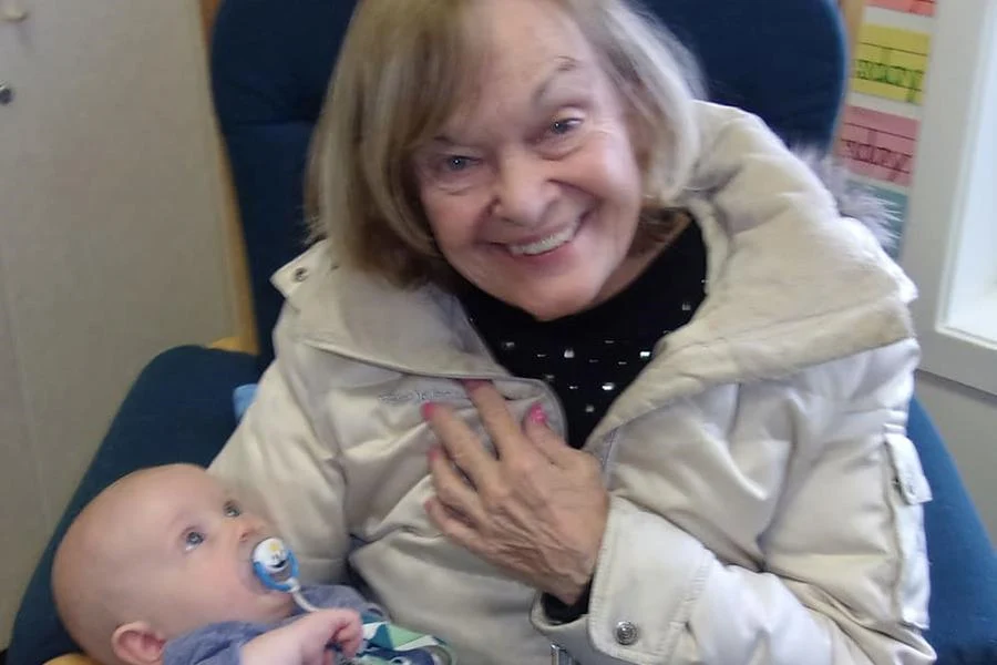 Porter Place Assisted Senior Living Memory Care in Tinley Park, IL resident holding a baby