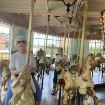 Willow Creek Gracious Retirement Living Hawthorn Senior Independent Living in Chesapeake, Virginia residents riding the carousel