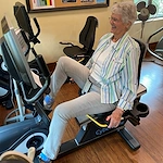 Covenant Living at the Samarkand in Santa Barbara, CA, resident utilizing the equipment in the community fitness room