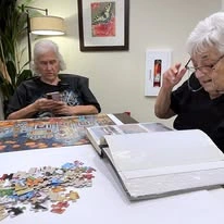 Hudson Estates Gracious Retirement Living Hawthorn Senior Independent Living in Lansdale, Pennsylvania residents reading and doing a puzzle
