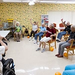 Wesley Manor Assisted Living Community offering assisted living and continuing care retirement community (CCRC) services in Louisville, KY, residents staying active as they take part in a fitness class