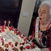 Stoneridge Gracious Retirement Living Hawthorn Senior Independent Living in Cary, North Carolina resident blowing out the candles on her birthday cake