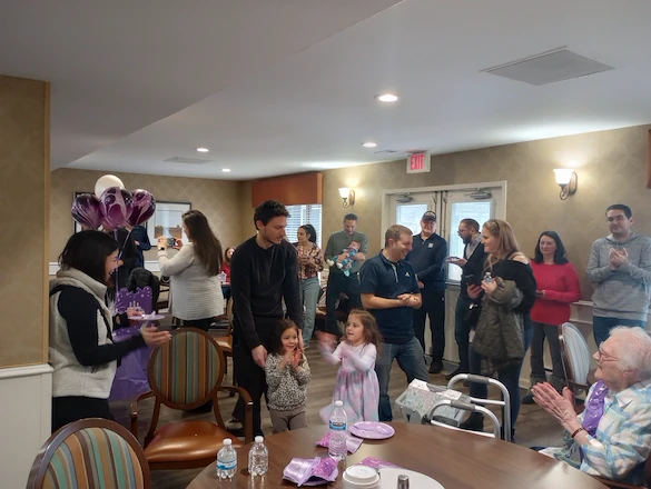 American House Sterling Heights, senior living community offering independent living and respite care in Sterling Heights, MI, residents with family during a celebration