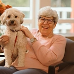 older woman and her white dog