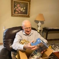 Ascension Living Via Christi Village Georgetown Senior Independent Living in Wichita, Kansas resident opening a present