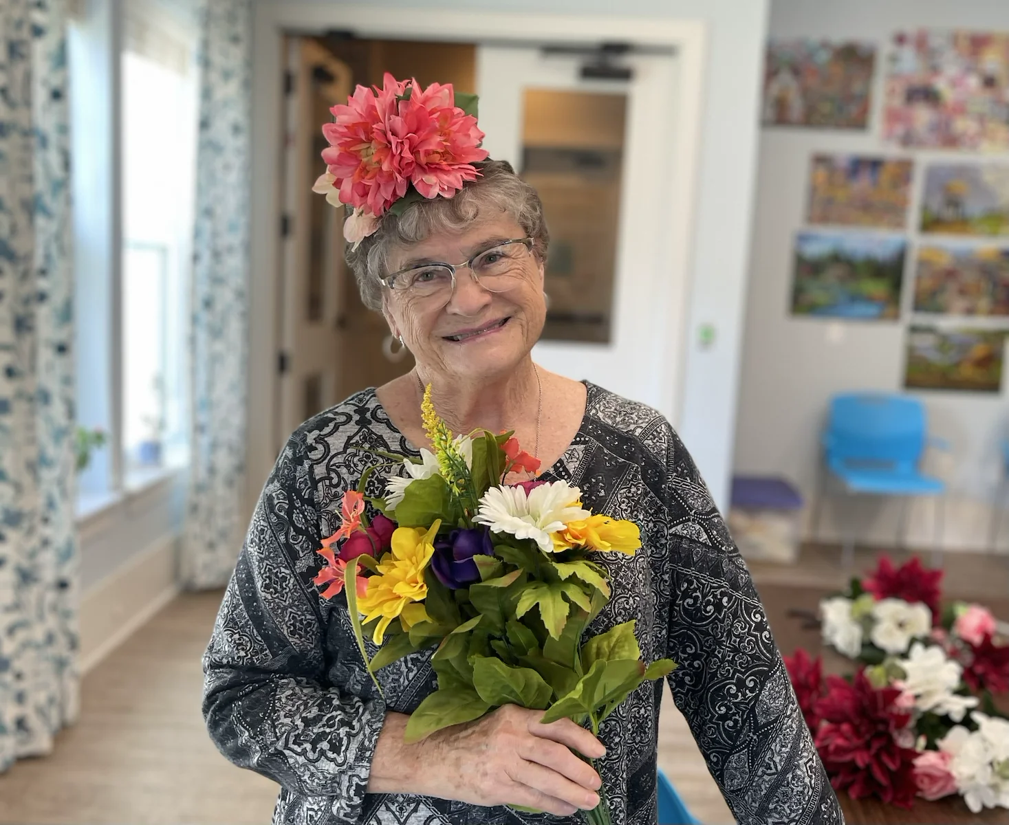 The Barclay at Little River smiling resident with floral creation