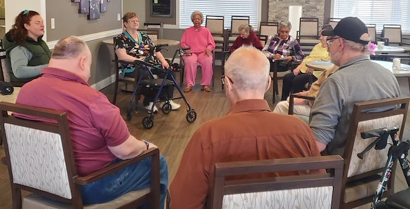 American House Westland Venoy senior living community offering independent living, assisted living, and respite care in Westland, MI, residents sitting in a circle and chatting