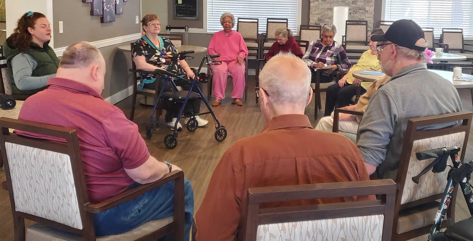 American House Westland Venoy senior living community offering independent living, assisted living, and respite care in Westland, MI, residents sitting in a circle and chatting