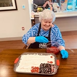 KindCare at Bristol, CT, smiling resident during baking activitiy