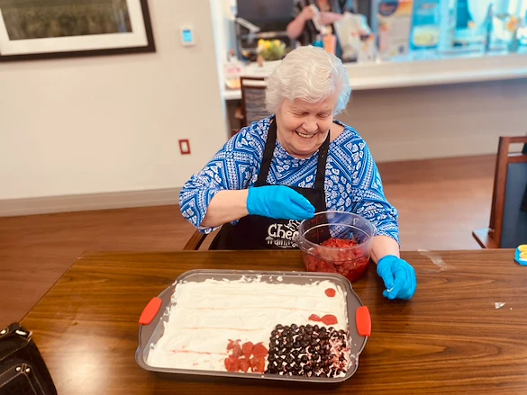 KindCare at Bristol, CT, smiling resident during baking activitiy