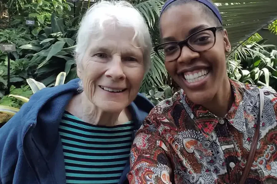 Harvester Place Senior Assisted Living Memory Care in Burr Ridge, IL resident smiling with a staff member