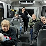 Seniors at Charter Senior Living of Hasmer Lake in Jackson, WI, riding together on a community van, enjoying group transportation for outings and social activities.