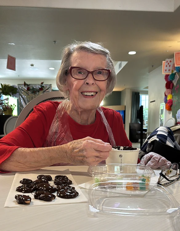 Chateau Valley Center in Renton, WA, smiling resident while making a fun treat