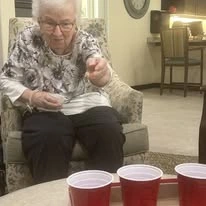 Camellia Gardens Gracious Retirement Living Hawthorn Senior Independent Living in Maynard, Massachusetts resident playing a red solo cup game