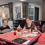 CopperWood at Prairie Trail senior living community offering assisted living and memory care in Ankeny, IA, residents enjoy dining and good company