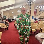 Fairview Estates Gracious Retirement Living Hawthorn Senior Independent Living in Hopkinton, Massachusetts resident in a Christmas themed suit