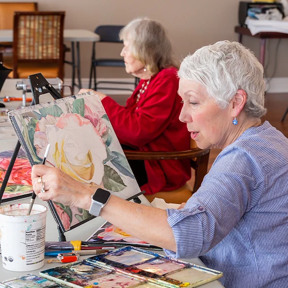 Piedmont Gardens Senior Living in Oakland, CA, resident enjoying an activity - painting