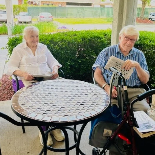 Whealdon Estates by Barclay House senior living community offering independent living in Baton Rouge, LA, residents gathered outside to enjoy some fresh air